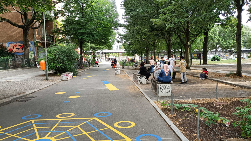 Planning is under way to develop a Kiezblock in Luisenstadt in Berlin-Kreuzberg. People can now stroll where cars were parked just two years ago. A flower bed allows rainwater to drain away and has a cooling effect
